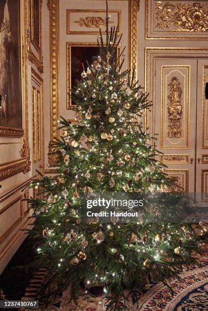 In this handout image released on December 24, the tree that formed the backdrop of the Queen's Christmas broadcast in the White Drawing Room at...