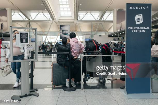 Travelers move through the departures hall at Terminal 4 of John F. Kennedy International Airport on December 24, 2021 in New York City. Thousands of...