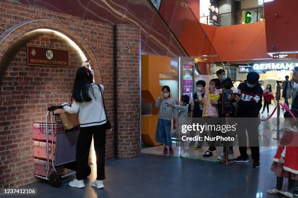 People take pictures at a Harry Potter-themed exposition in the Megabox mall on Christmas eve.