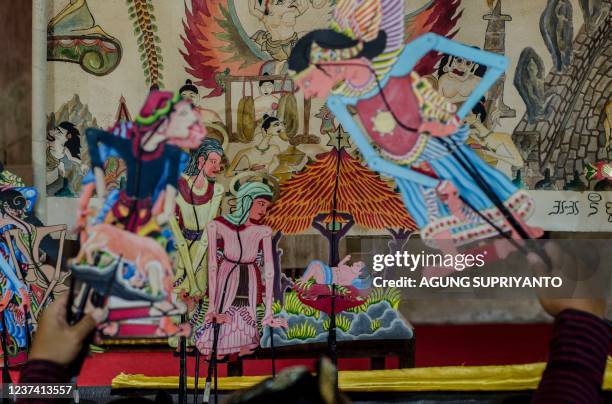 This photo taken on December 24, 2021 shows Christmas-themed puppetry played by puppet master Indra Suroinggeno in Bantul, Yogyakarta. - A small...
