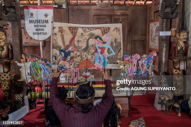 This photo taken on December 24, 2021 shows puppet master Indra Suroinggeno playing Christmas-themed puppetry in Bantul, Yogyakarta. - A small...