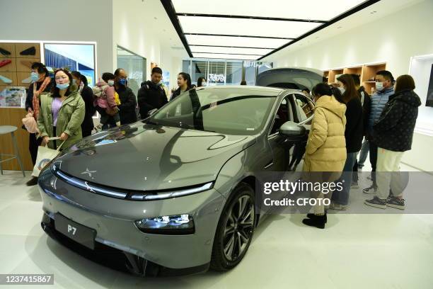 Customers come to experience new energy electric vehicles at the Xiaopeng experience store in Wanda Plaza store in Shanghai, China, On December 25,...