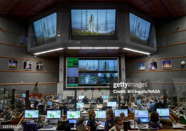 Launch teams monitor the countdown to the launch of Arianespace's Ariane 5 rocket carrying NASAs James Webb Space Telescope on December 25 in the...