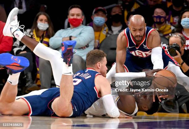 Blake Griffin and Bruce Brown of the Brooklyn Nets and Darren Collison of the Los Angeles Lakers scramble for a loose ball in the first half of the...