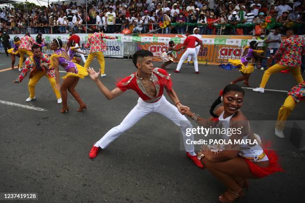 Revellers perform during the 'Salsodromo', the kick-off of the music and cultural festival Feria de Cali in Cali, Colombia, on December 25, 2021. -...