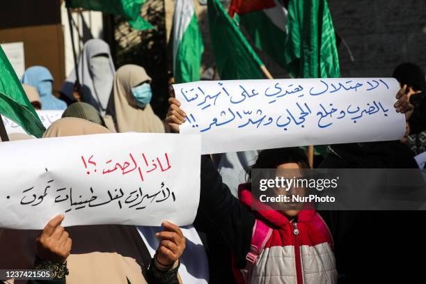 Palestinian women attend a protest organised by Hamas in solidarity with female Palestinian prisoners held in Israeli jails, outside the Red Cross...