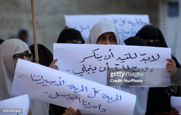 Palestinian women attend a protest organised by Hamas in solidarity with female Palestinian prisoners held in Israeli jails, outside the Red Cross...