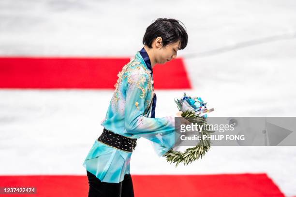 Gold medallist Japan's Yuzuru Hanyu takes part in the victory ceremony for the men's free skate during the 2021-22 Japan Figure Skating Championships...