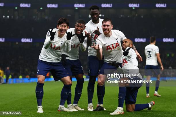 Tottenham Hotspur's South Korean striker Son Heung-Min celebrates with teammates after scoring their third goal during the English Premier League...