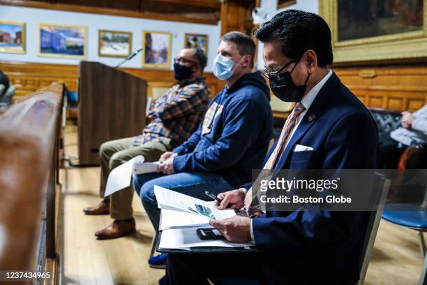 Lowell, MA Paul Ratha-Yem, foreground, a newly elected Lowell City Councilman who will be sworn in on January 3 attends a city council meeting in...