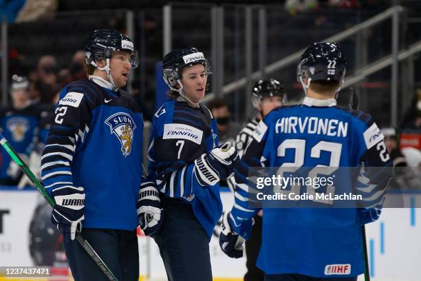 Joel Määttä, Topi Niemelä and Roni Hirvonen of Finland celebrate a goal against Austria in the third period during the 2022 IIHF World Junior...