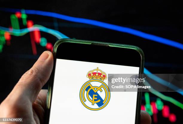 In this photo illustration the Spanish professional football club team Real Madrid Club de Fútbol commonly known as Real Madrid logo seen displayed...