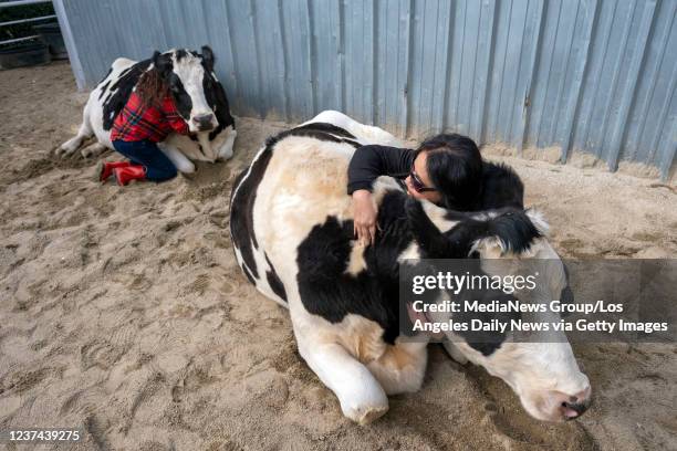 Santa Clarita, CA Nora Castro and daughter Sarah hug cows at the Gentle Barn in Santa Clarita, CA, Tuesday, Dec 21, 2021. The mother and daughter...