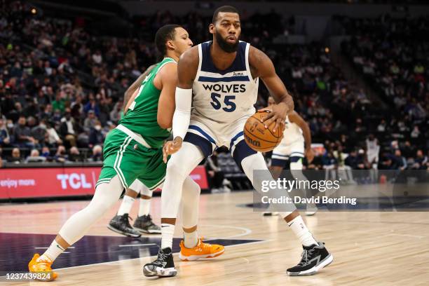 Greg Monroe of the Minnesota Timberwolves dribbles the ball against Grant Williams of the Boston Celtics in the second quarter at Target Center on...