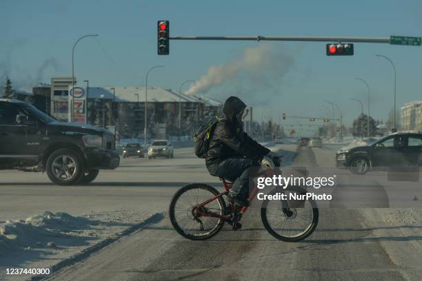 Cyclist seen on Ellerslie Road in the southwestern part of Edmonton. The Edmonton and northern Alberta areas are experiencing a prolonged period of...