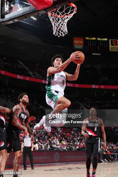 Josh Green of the Dallas Mavericks drives to the basket during the game against the Portland Trail Blazers on December 27, 2021 at the Moda Center...