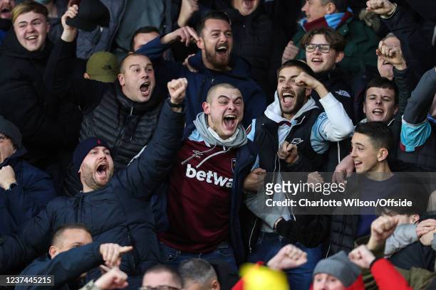 West Ham fans celebrate their 2nd goal during the Premier League match between Watford and West Ham United at Vicarage Road on December 28, 2021 in...