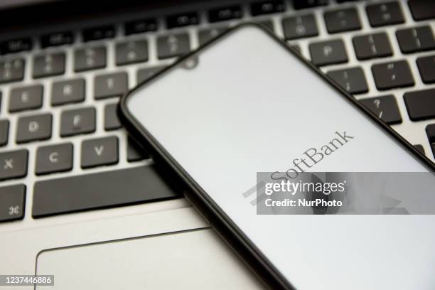 In this photo illustration a SoftBank logo seen displayed on a smartphone screen with a computer keyword in the background in Athens, Greece on...