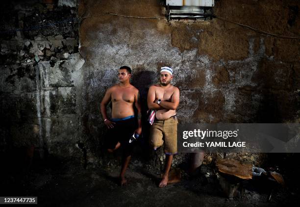 Two initiates of the men's religious secret society known as Abakua rest after taking part in the oath ceremony of the Efi Barondi Cama "potency" in...