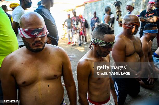 Group of initiates of the men's religious secret society known as Abakua remain on their knees during the oath ceremony of the Efi Barondi Cama...