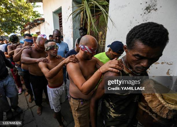 Group of blindfolded initiates of the men's religious secret society known as Abakua take part in the oath ceremony of the Efi Barondi Cama "potency"...