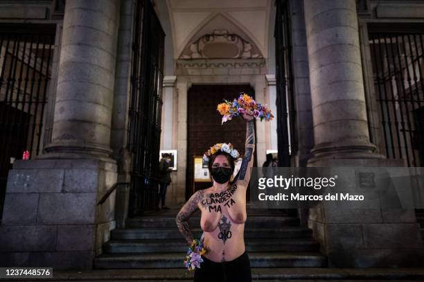 An activist from the feminist group FEMEN protests with her bare chest and the written words 'clandestine abortion kills' at the door of the...