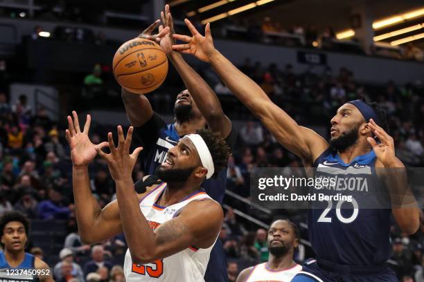 Mitchell Robinson of the New York Knicks and Josh Okogie of the Minnesota Timberwolves compete for the ball in the second quarter of the game at...