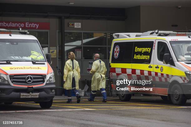 Paramedics walk past ambulances at St Vincent's Hospital in Sydney, Australia, on Wednesday, Dec. 29, 2021. Hospitalizations due to coronavirus in...