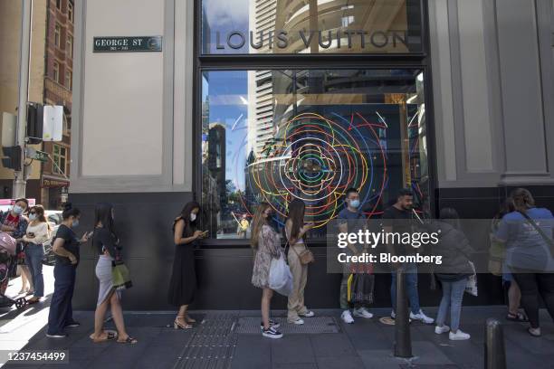 Shoppers wait in line outside a Louis Vuitton store, operated by Moet Hennessy Louis Vuitton SE LVMH, in Sydney, Australia, on Wednesday, Dec. 29,...