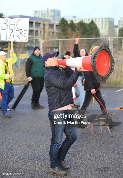 Protesters uses a bollard as a megaphone as demonstrators disrupt the vaccination centre entering the site with banners and signs on December 29,...