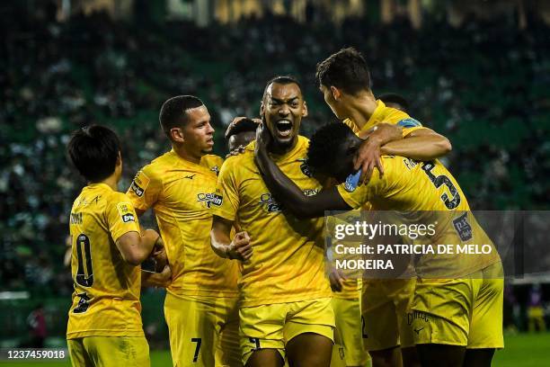 Portimonense's Brazilian forward Fabricio celebrates with teammates after scoring a goal during the Portuguese League football match between Sporting...