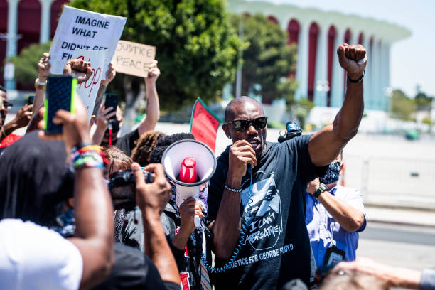 Former NFL wide receiver Terrell Owens leads a protest march in support of quarterback Colin Kaepernick, whose kneeling protests against police...