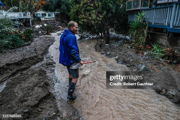 Silverado Canyon, CA, Wednesday, December 29, 2021 - Mitch Vincent keeps a lookout on a rising stream of water threatening his parents home. Visiting...