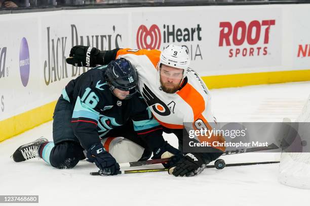 Jared McCann of the Seattle Kraken and Ivan Provorov of the Philadelphia Flyers collide while attempting to gain control of the puck during the third...