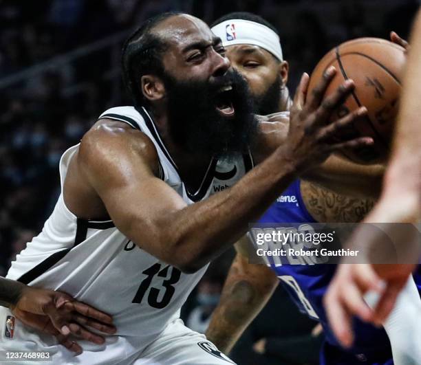 Los Angeles, CA, Monday, December 27, 2021 - Brooklyn Nets guard James Harden strains to get past LA Clippers forward Marcus Morris Sr. In the first...