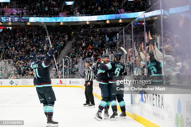 Jeremy Lauzon celebrates with Adam Larsson after scoring a goal during the third period against the Philadelphia Flyers at Climate Pledge Arena on...