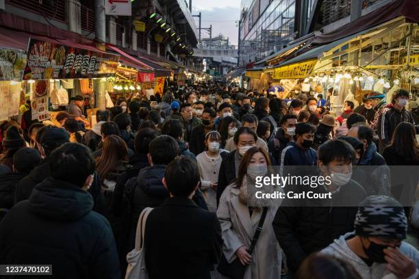 People pass along Ameyoko shopping street as they do end of year shopping on December 30, 2021 in Tokyo, Japan. Tokyo Metropolitan Government...