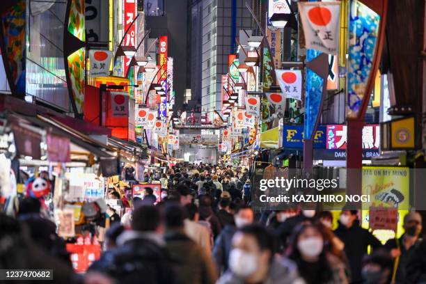 People visit shops to purchase food and supplies to celebrate the new year in Tokyo's Ueno shopping district on December 30, 2021.