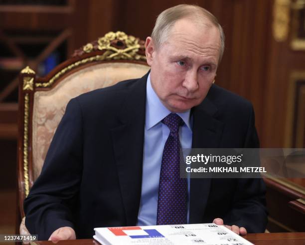 Russia's President Vladimir Putin meets with local Russian officials in the Kremlin in Moscow, on December 30, 2021. - US President Joe Biden and his...