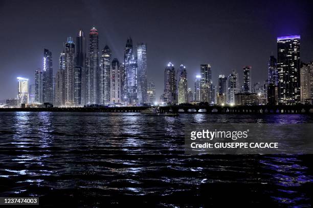 This picture taken on December 29, 2021 shows a view of skyscrapers along the Dubai Marina waterfront in the Gulf emirate.