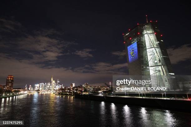 The tower of the European Central Bank main building is pictured by night showing the illuminated euro currency symbol in Frankfurt/Main, western...