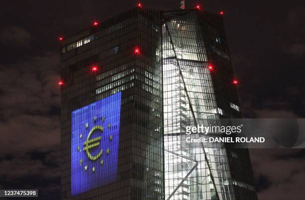 The tower of the European Central Bank main building is pictured by night showing the illuminated euro currency symbol in Frankfurt/Main, western...