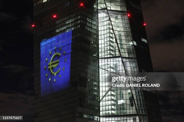 The tower of the European Central Bank main building is pictured by night showing the illuminated euro currency symbol in Frankfurt/Main, western...