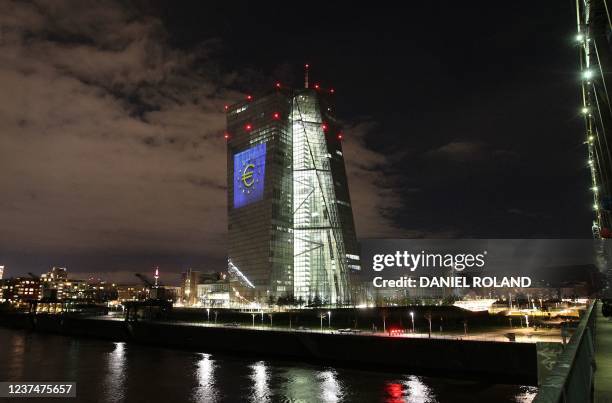 The tower of the European Central Bank main building is pictured by night showing the illuminated euro currency symbol in Frankfurt/Main, western...