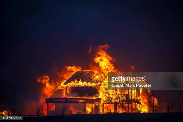 Home burns after a fast moving wildfire swept through the area in the Centennial Heights neighborhood of Louisville, Colorado on December 30, 2021....