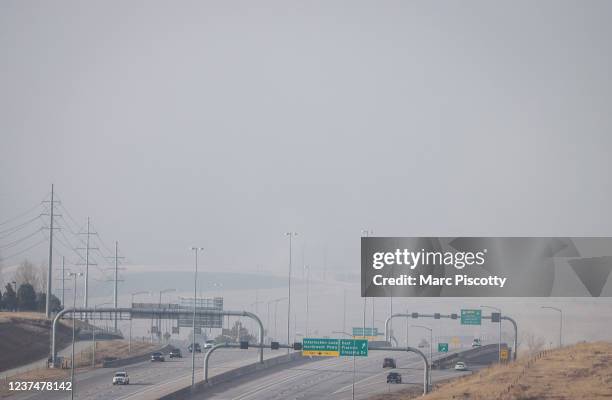 Smoke and haze fills the sky over US 36 due to fast moving wildfires in the area on December 30, 2021 in Broomfield, Colorado. State officials...