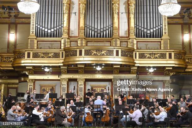 Musicians of the Vienna Philharmonic perform during a rehearsal of the 2022 New Year's Concert in the Golden Hall of the Musikverein in Vienna,...