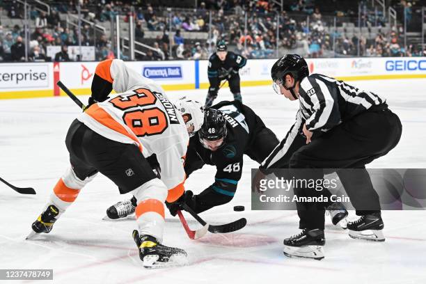Tomas Hertl of the San Jose Sharks takes a face-off against Patrick Brown of the Philadelphia Flyers in a regular season game at SAP Center on...