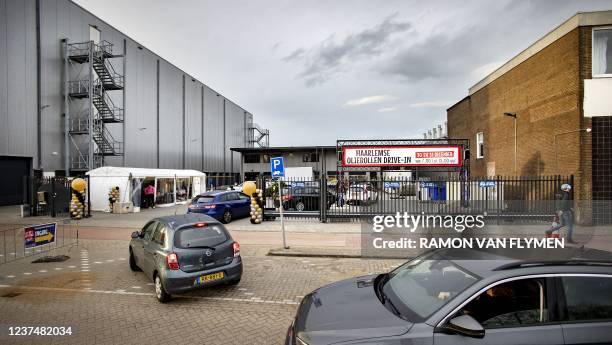 Customers queue on New Year's Eve at the oliebollen drive-thru of the Haarlemse Bakker in the Waarderpolder, in Haarlem on December 31, 2021. - Most...