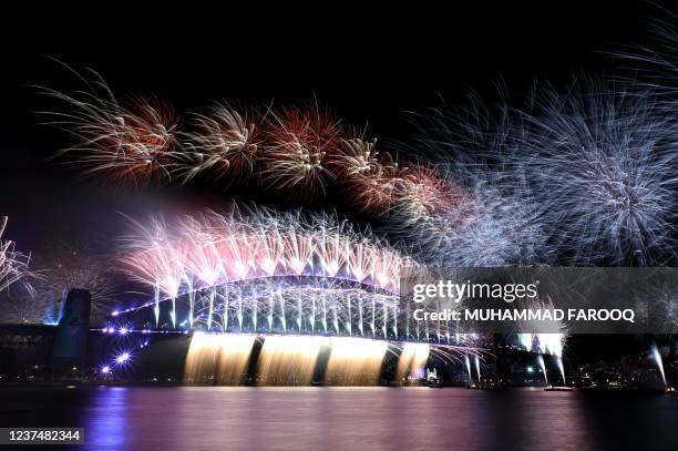 New Year's Eve fireworks light up the sky over Sydney's iconic Harbour Bridge during the fireworks show on January 1, 2022.